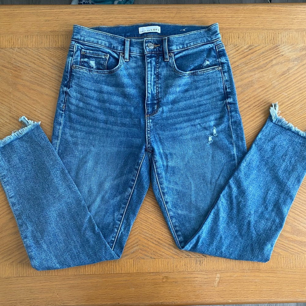 Loft skinny jeans with distressed bottoms